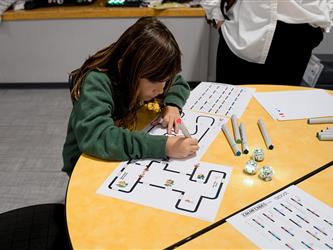 Student coding an Ozobot